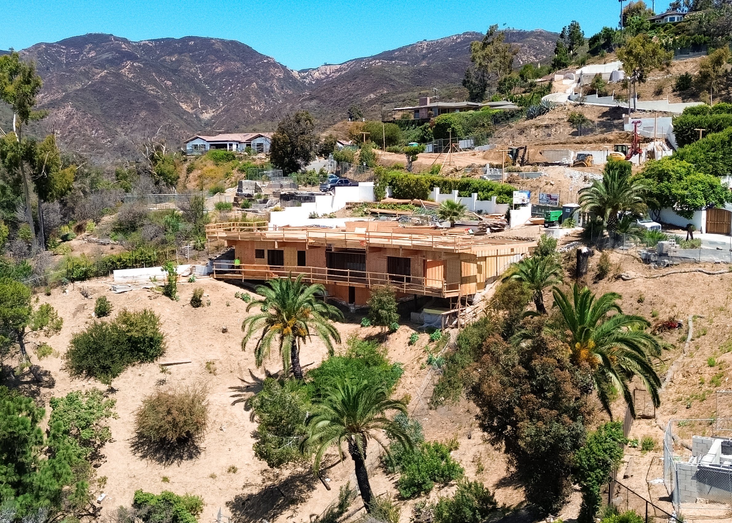A Los Angeles canyon from the air, homes stepping down the slope toward the coast